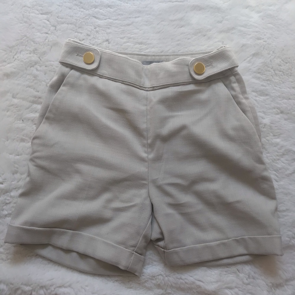Cream trouser shorts with golden button detail